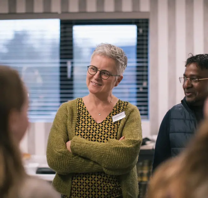 Een glimlachende dame tijdens de Pgax Klantendag van 7-12-2023